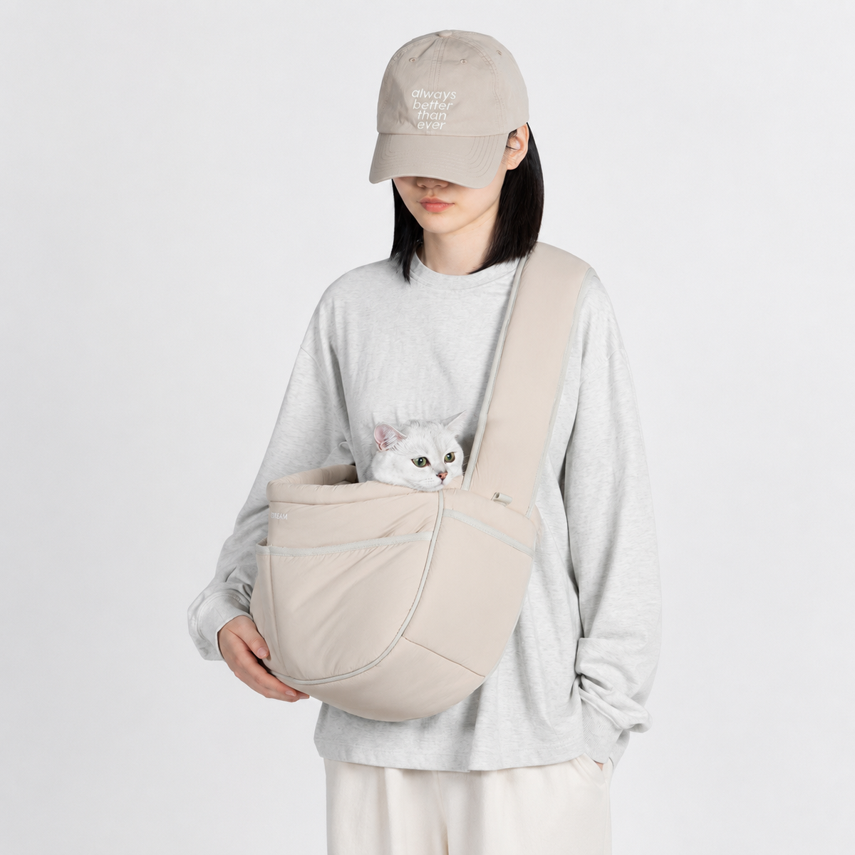 Cat carried close to the body in a soft sling