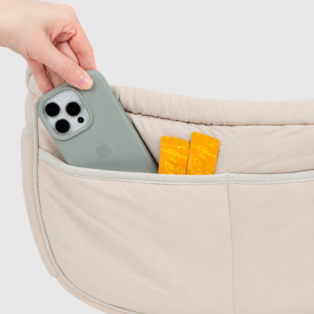 Phone and cards stored in the sling carrier front pocket
