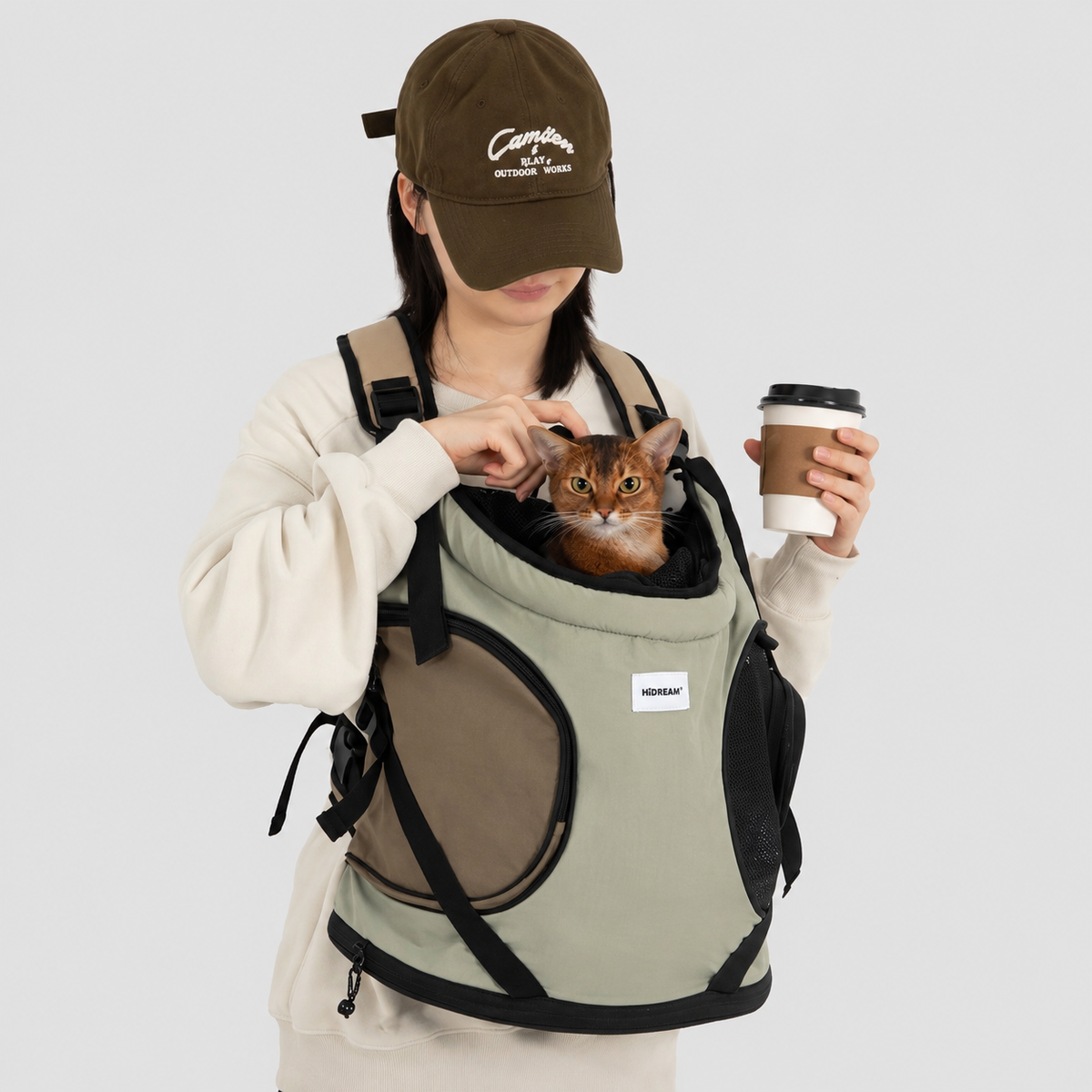 Owner reassuring a cat in a front carrier