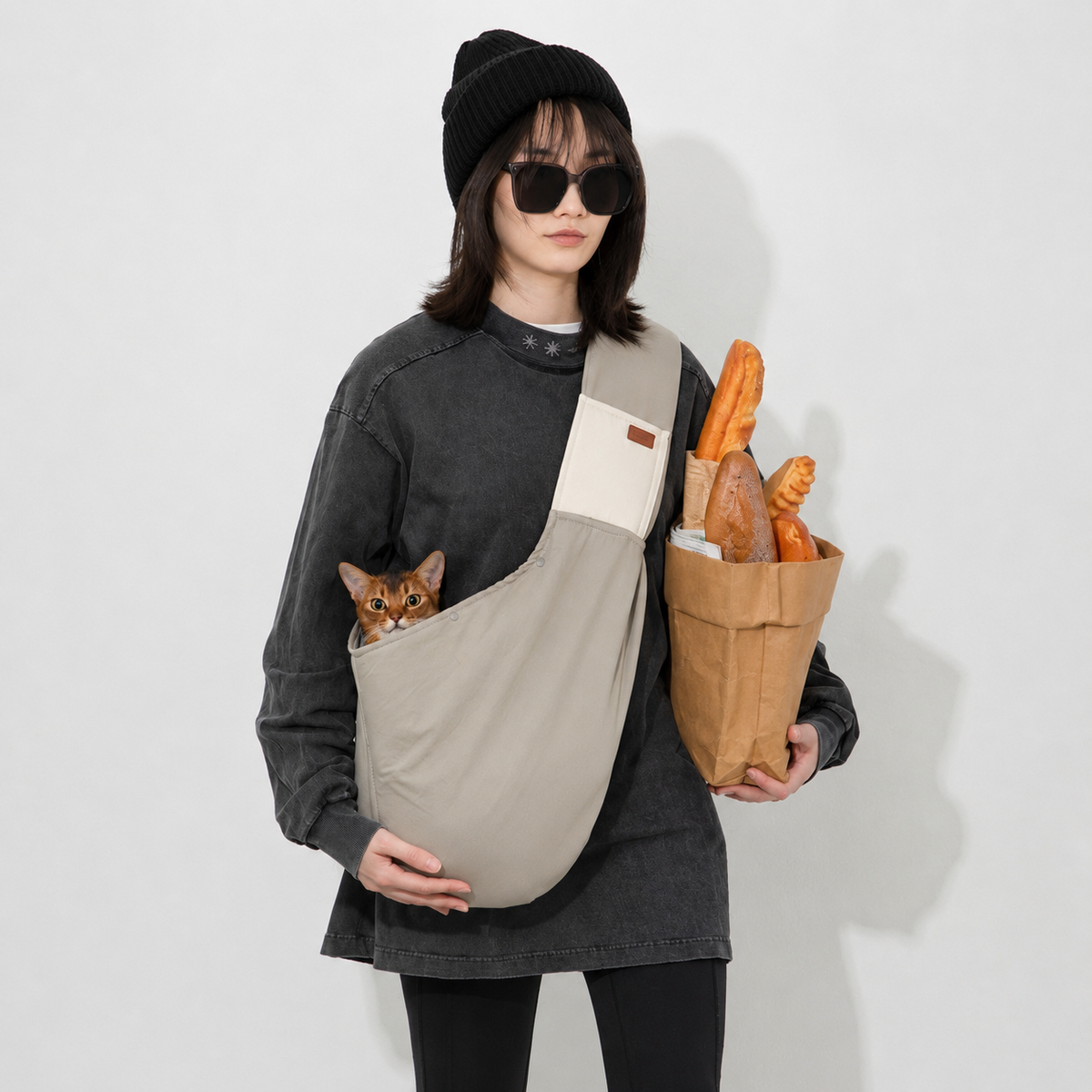 Cat carried in a wide shoulder sling during shopping