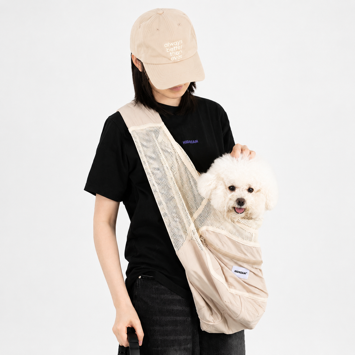 Woman carrying a small dog close to her body in a sling