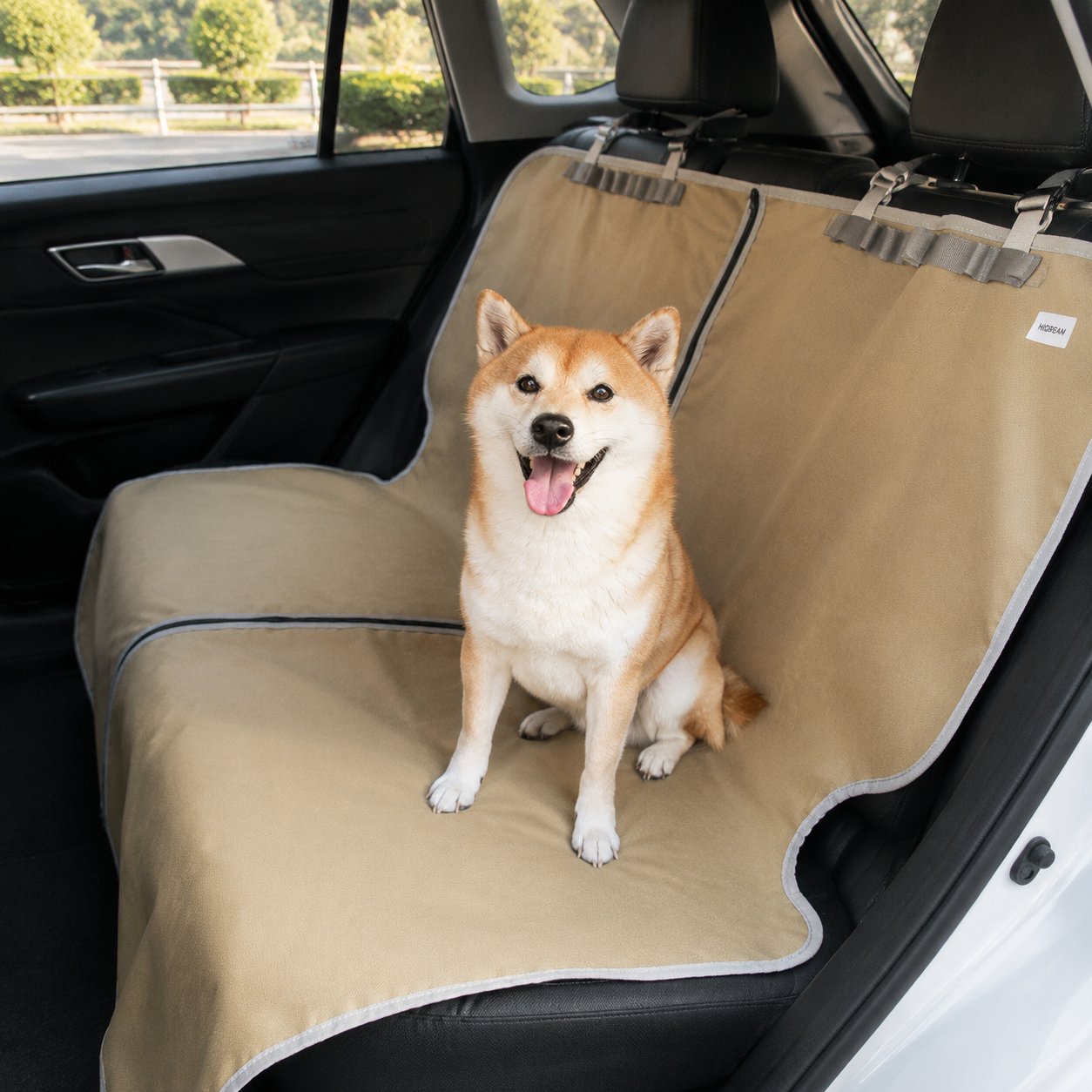 Dog sitting on a waterproof rear bench car seat cover